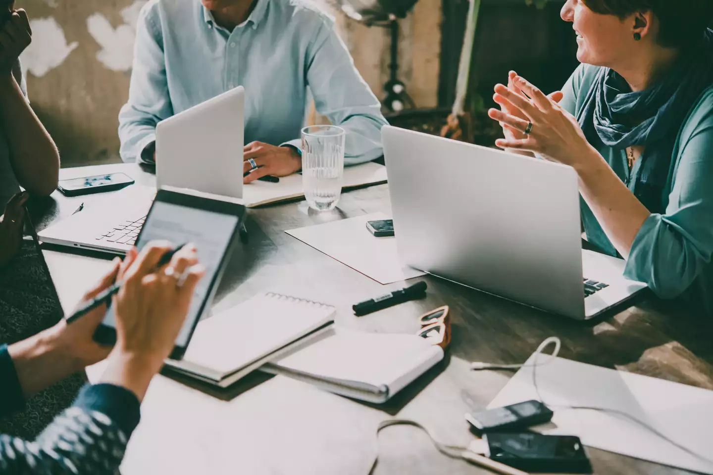 Mitarbeitende an Laptops und Tablets